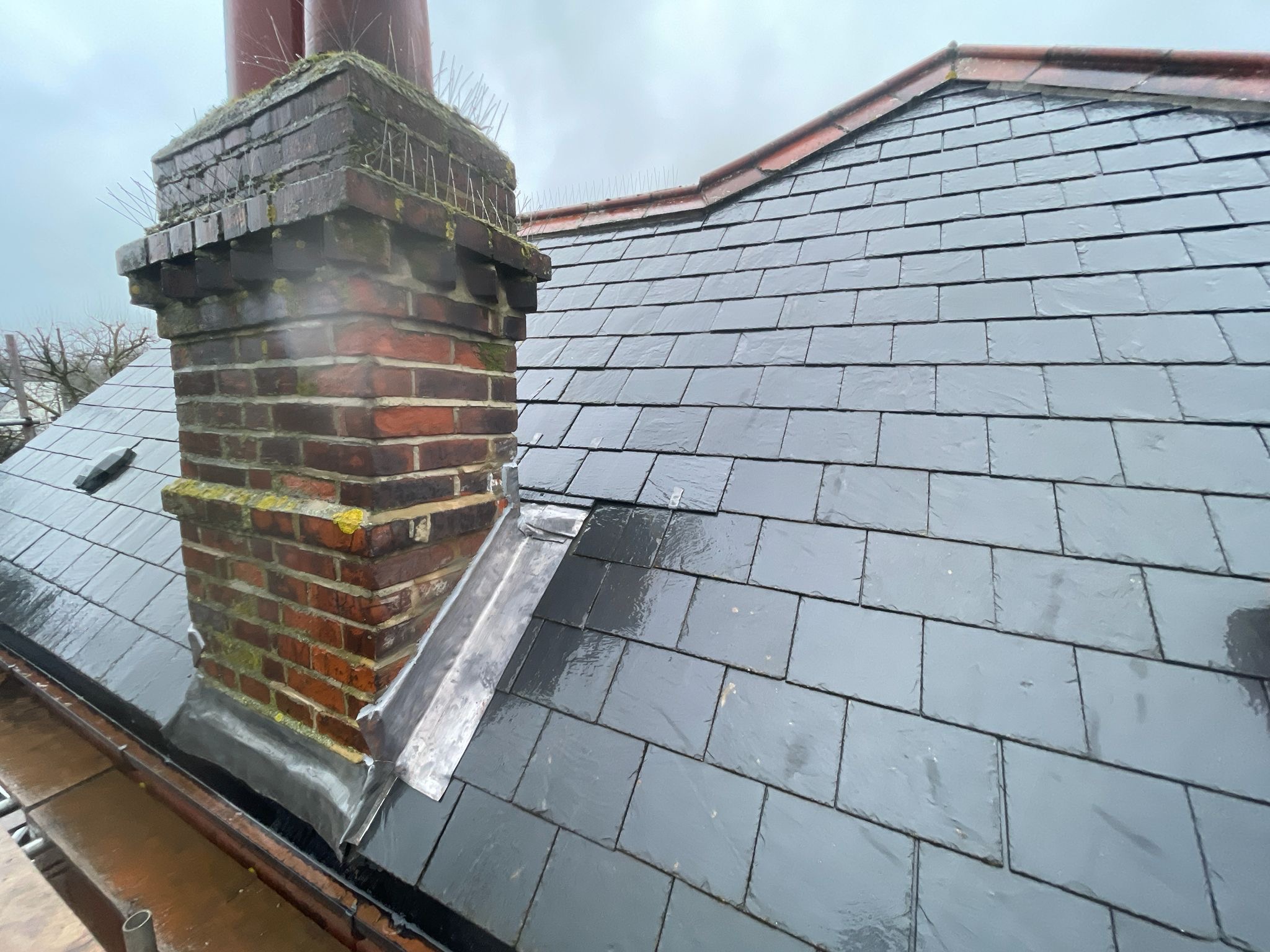 Chimney with lead flashing on slate roof